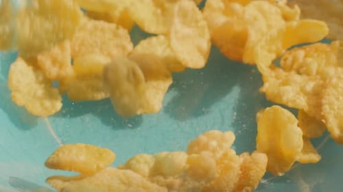 Corn flakes. Slow motion falls into the plate.
