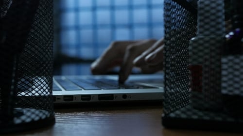 Hands Typing on Laptop Keyboard at Night