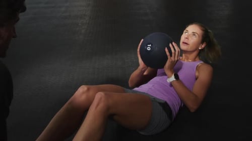 Front view athletic Caucasian friends doing abdominal exercises