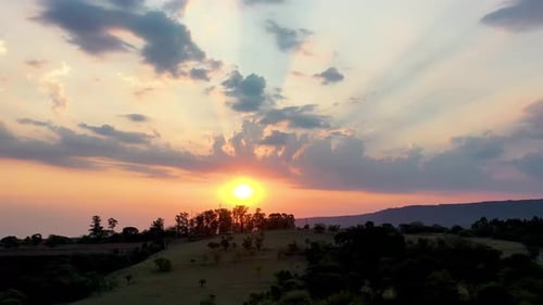 Colorful Sunset Over Rolling Hills Landscape