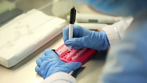 Scientist Labeling Vials in Lab, Medical Research