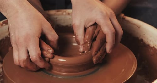 Hands Forming Clay on Pottery Wheel