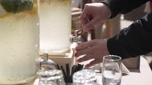 Pouring Refreshing Beverage at Outdoor Celebration
