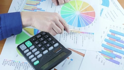 Businessman Analyzing Graph And Calculating