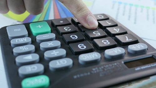 Hand Calculating Data Using Calculator Machine