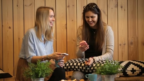 Beautiful Girls Sitting In Cafe With Tea