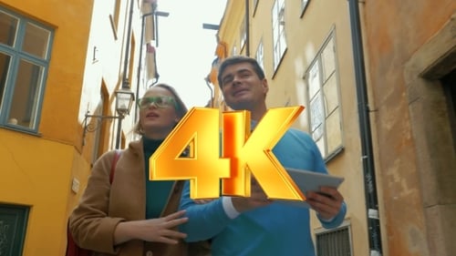 Young Couple With Pad Walking In Old Narrow Street