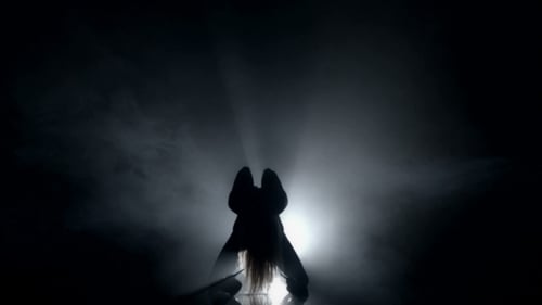 Silhouette of Athletic Dancer Moving in Smoke