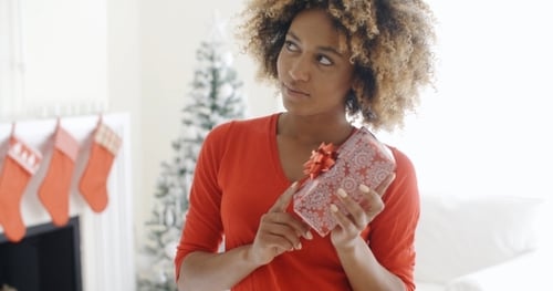 African Woman Holding a Christmas Gift