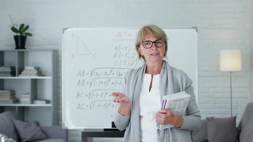 Woman Explaining Math in Front of Whiteboard