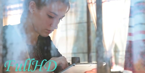 Beautiful Girl in Cafe With a Tablet