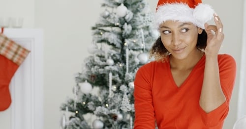 Festive Woman Smiling in Red Christmas Hat