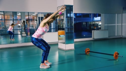 Woman Doing Bodyweight Squats at the Gym