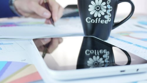 Businessman Using Tablet With Coffee