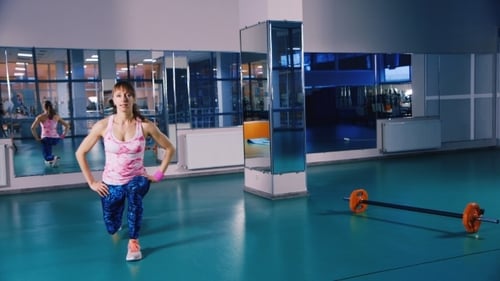 Woman Doing Lunges in Modern Gym