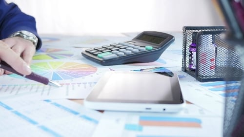 Businessman Analyzing Diagram And Calculation