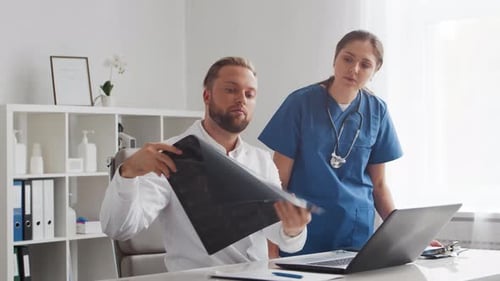 Professional medical doctors working in hospital office. Physician and the young nurse.