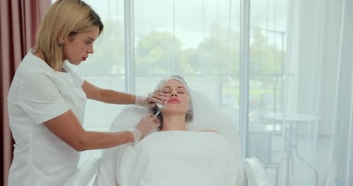 Woman Receiving Cosmetic Facial Injection in Spa