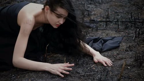 Distressed Woman Crawling Through Scorched Earth