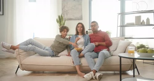 Family Relaxing and Watching TV at Home