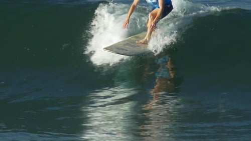 Surfer Rides a Wave in the Ocean