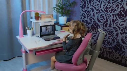 Girl Attends Online Class at Her Desk