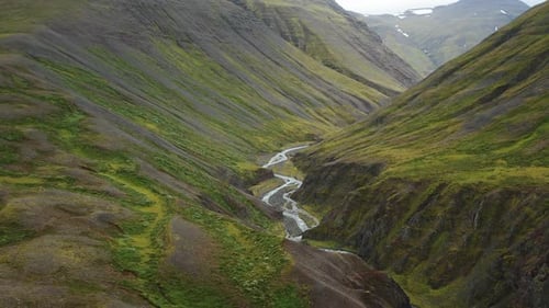 Drone Flight Over Green Hills Canyon and Small River in Iceland Summertime