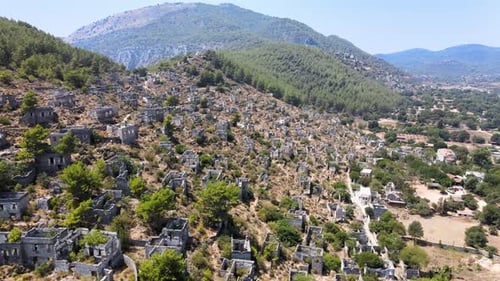 Drone flight close-up over the ruins of an ancient fortress located in the green mountain hills of T