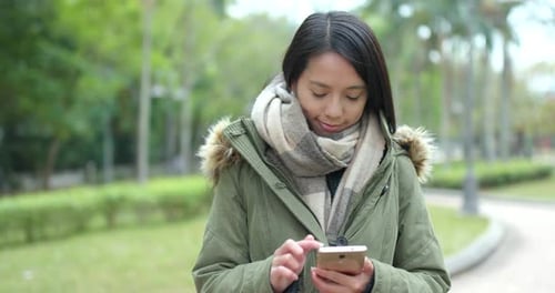 Woman use of mobile phone at park