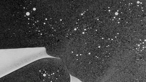 Black liquid forming abstract forms on a whit surface.