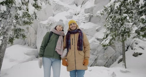 Slow Motion Portrait of Happy Young Man and Woman Standing in Winter Woods Enjoying Journey