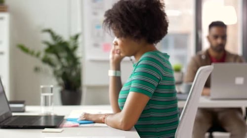 Ui Designers with Templates and Laptop at Office 22