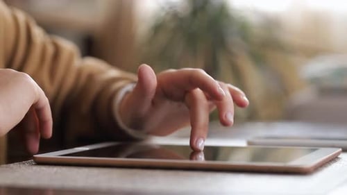 Close-up fingers swipe tablet screen