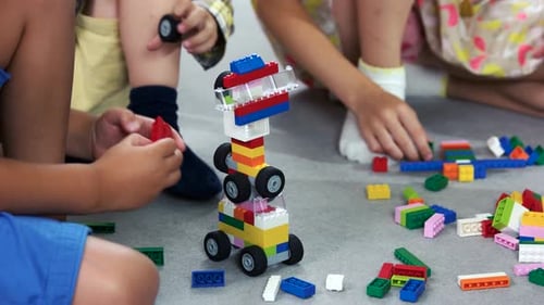 Close Up Kids Playing with Block Toys in Nursery School