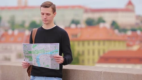 Man Looking at Map While Traveling in Europe