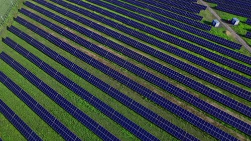 Aerial View of Solar Panels Stand in a Row in the Fields
