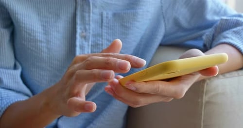 Close up of woman use of smart phone at home