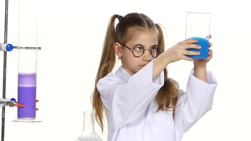 Young Girl Studying Blue Liquids in Science Lab