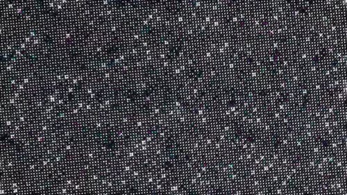 dots of light shining in on a black background