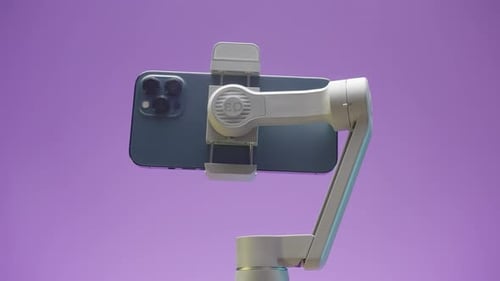 Smartphone on Gimbal Rotating on Purple Backdrop
