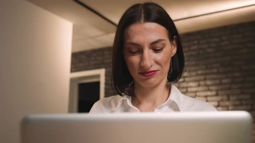 Woman using Laptop in an Indoor Setting