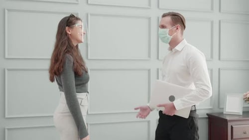 Elbow Bump Greeting With Face Mask and Shield