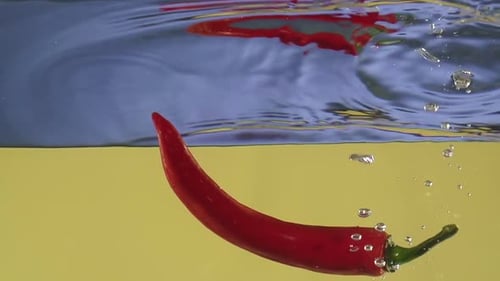 Red Chili Peppers Splashing in Water