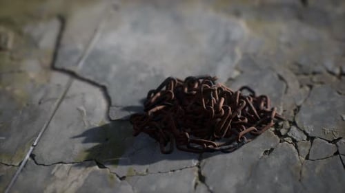 Rusty Iron Chains on Cracked Stone Floor