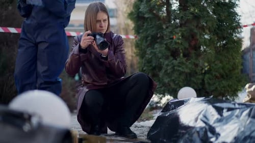 Woman Takes Photos at an Investigation Scene