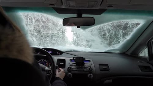 Person Removing Snow blocking Road on Winter Day