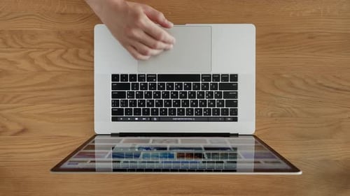 Hands Type on Laptop Keyboard on Wooden Desk