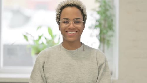 Young Woman Smiling Indoors with Natural Light