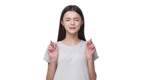 Young Woman Crossing Fingers Making a Wish