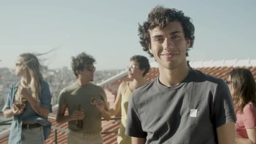 Friends enjoying rooftop party in city sunlight
